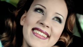 Close-up of Bl&uuml;mchen's face; she is smiling and looking up and to the right.